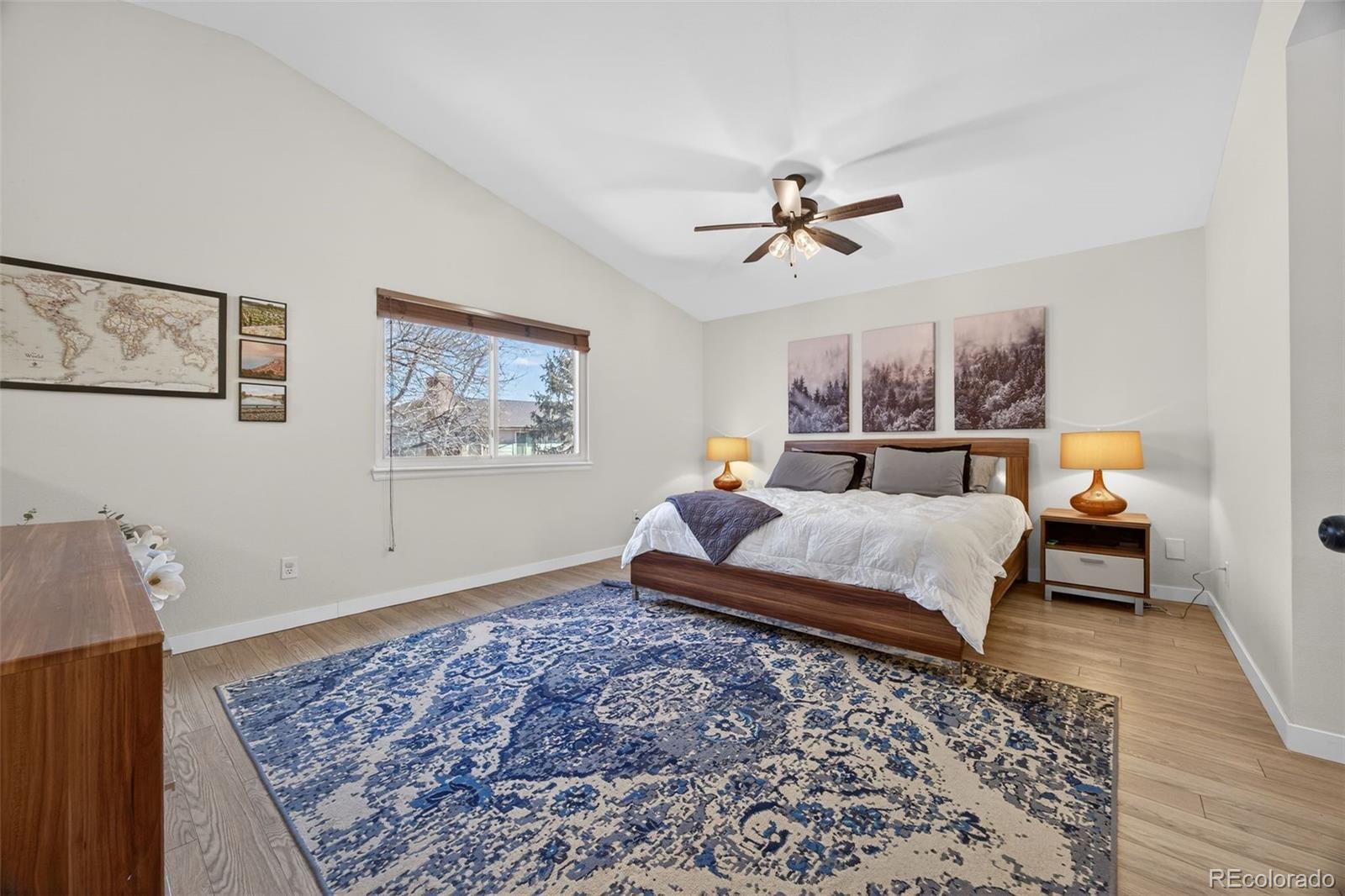 8764 Wildrose Court Highlands Ranch, CO 80126 - Photo 4 of 50 a bed room with a bed and wooden floor