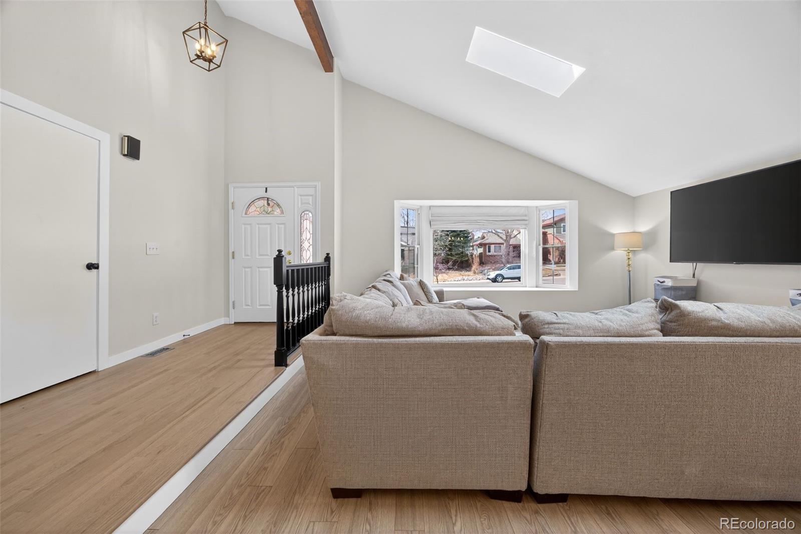 8764 Wildrose Court Highlands Ranch, CO 80126 - Photo 41 of 50 a living room with furniture and a flat screen tv