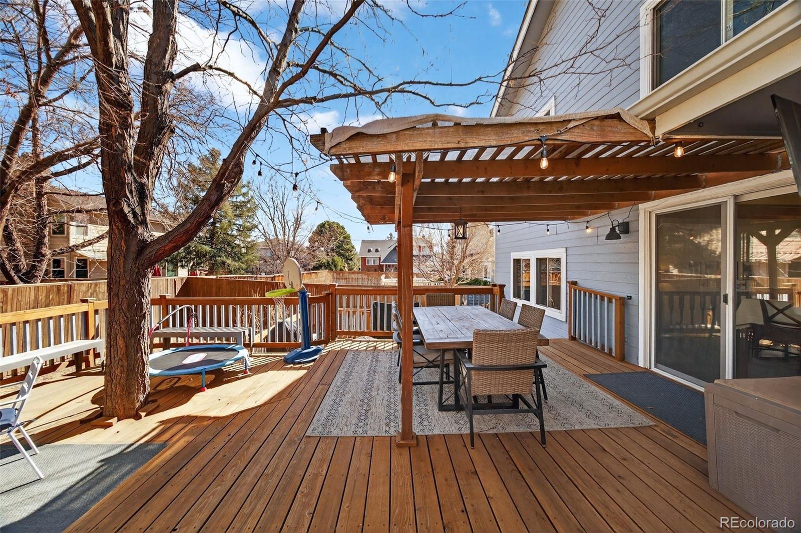 8764 Wildrose Court Highlands Ranch, CO 80126 - Photo 42 of 50 a view of a chairs and table on the wooden floor