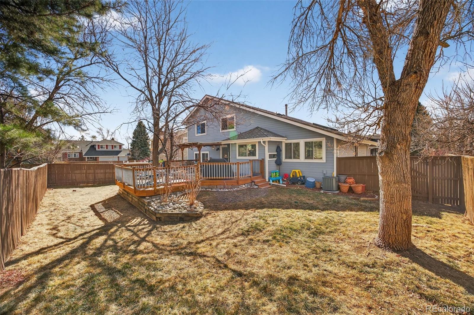 8764 Wildrose Court Highlands Ranch, CO 80126 - Photo 43 of 50 a front view of a house with a yard covered in snow