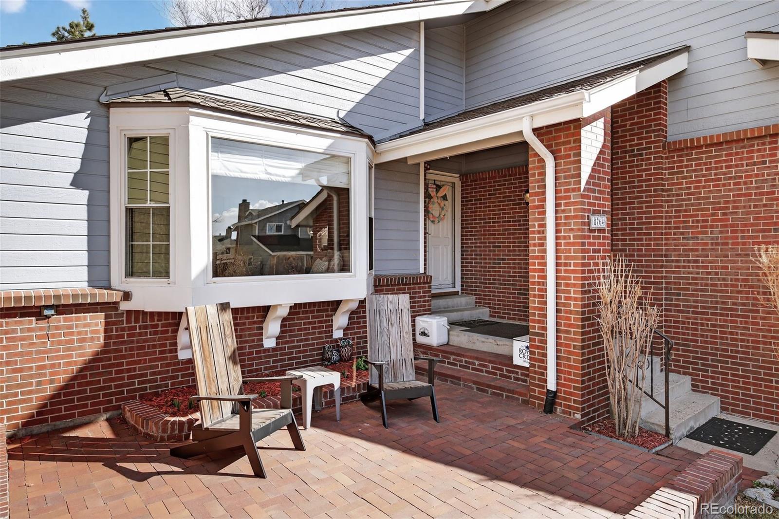 8764 Wildrose Court Highlands Ranch, CO 80126 - Photo 48 of 50 a front view of a house with outdoor seating