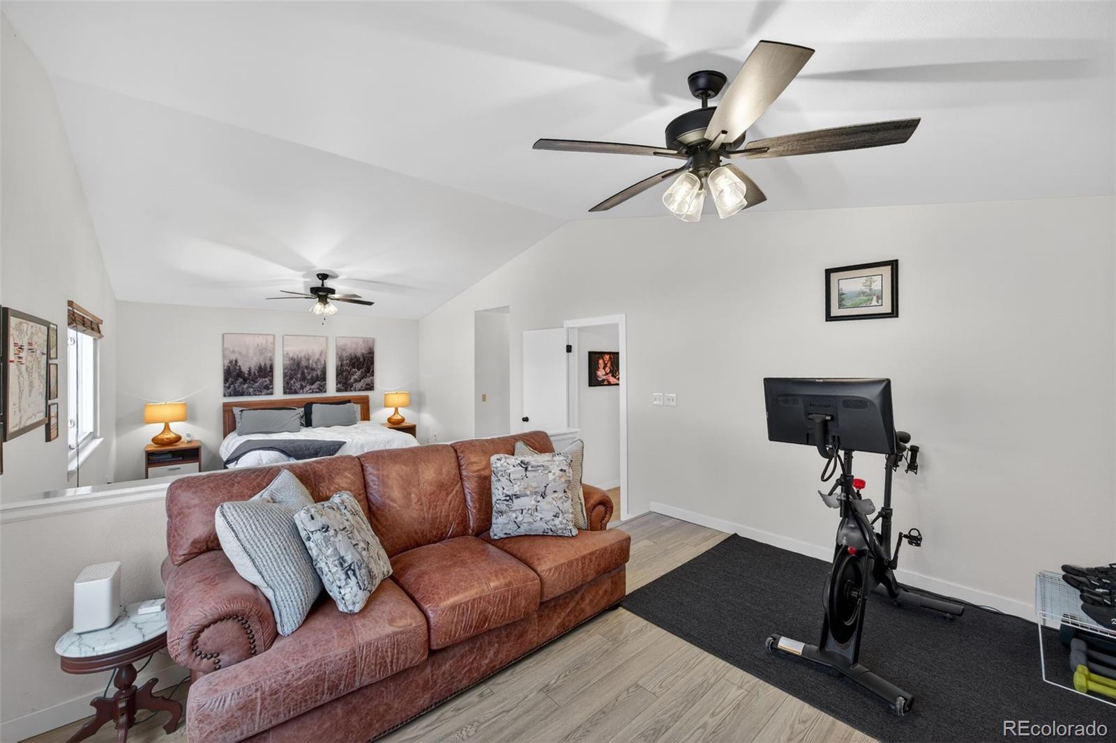 8764 Wildrose Court Highlands Ranch, CO 80126 - Photo 5 of 50 a living room with furniture a two couches and a flat screen tv