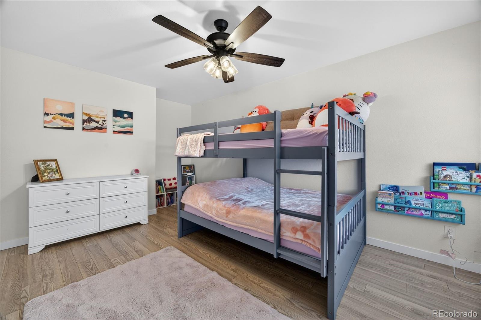 8764 Wildrose Court Highlands Ranch, CO 80126 - Photo 7 of 50 a bedroom with a bed and wooden floor