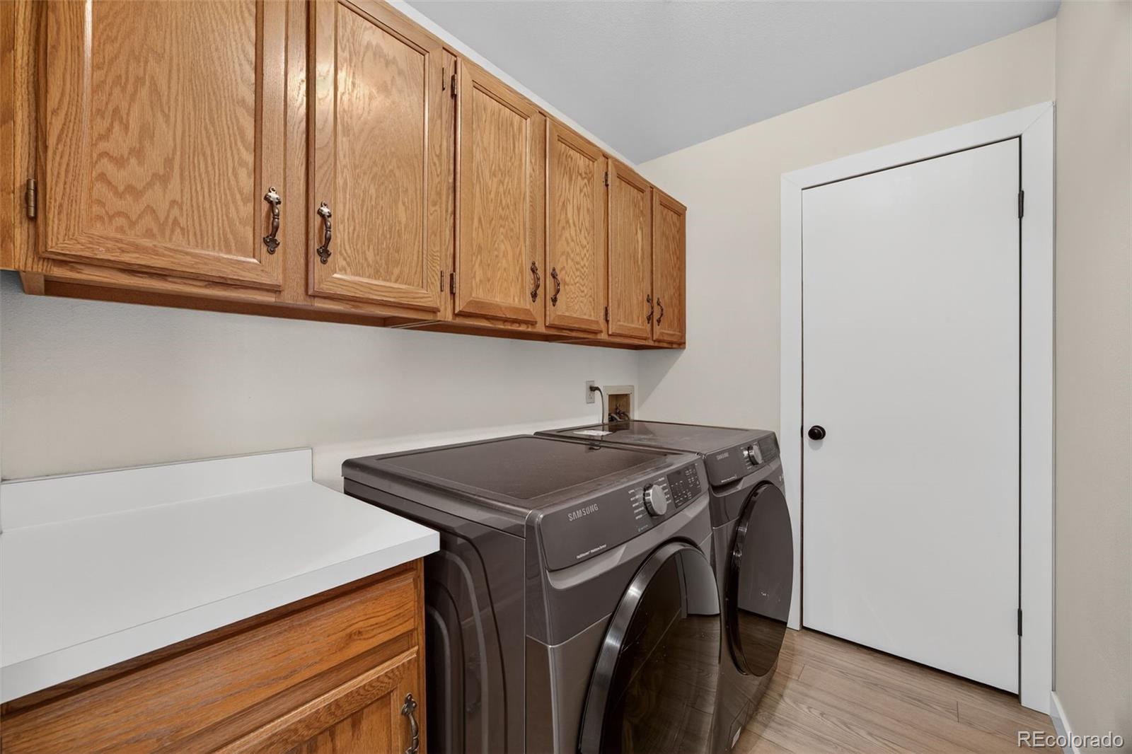 8764 Wildrose Court Highlands Ranch, CO 80126 - Photo 9 of 50 a utility room with dryer and washer