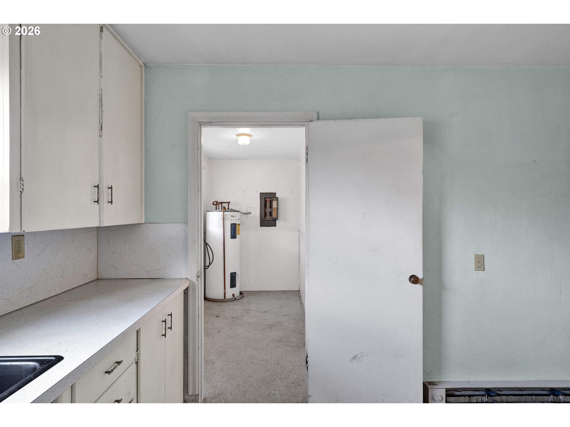 930 1st Street Springfield, OR 97477 - Photo 11 of 43 a kitchen with a refrigerator and white cabinets