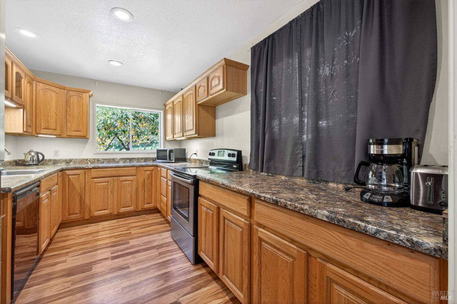 3320 Redwood Road Napa, CA 94558 - Photo 38 of 57 a kitchen with sink cabinets and wooden floor