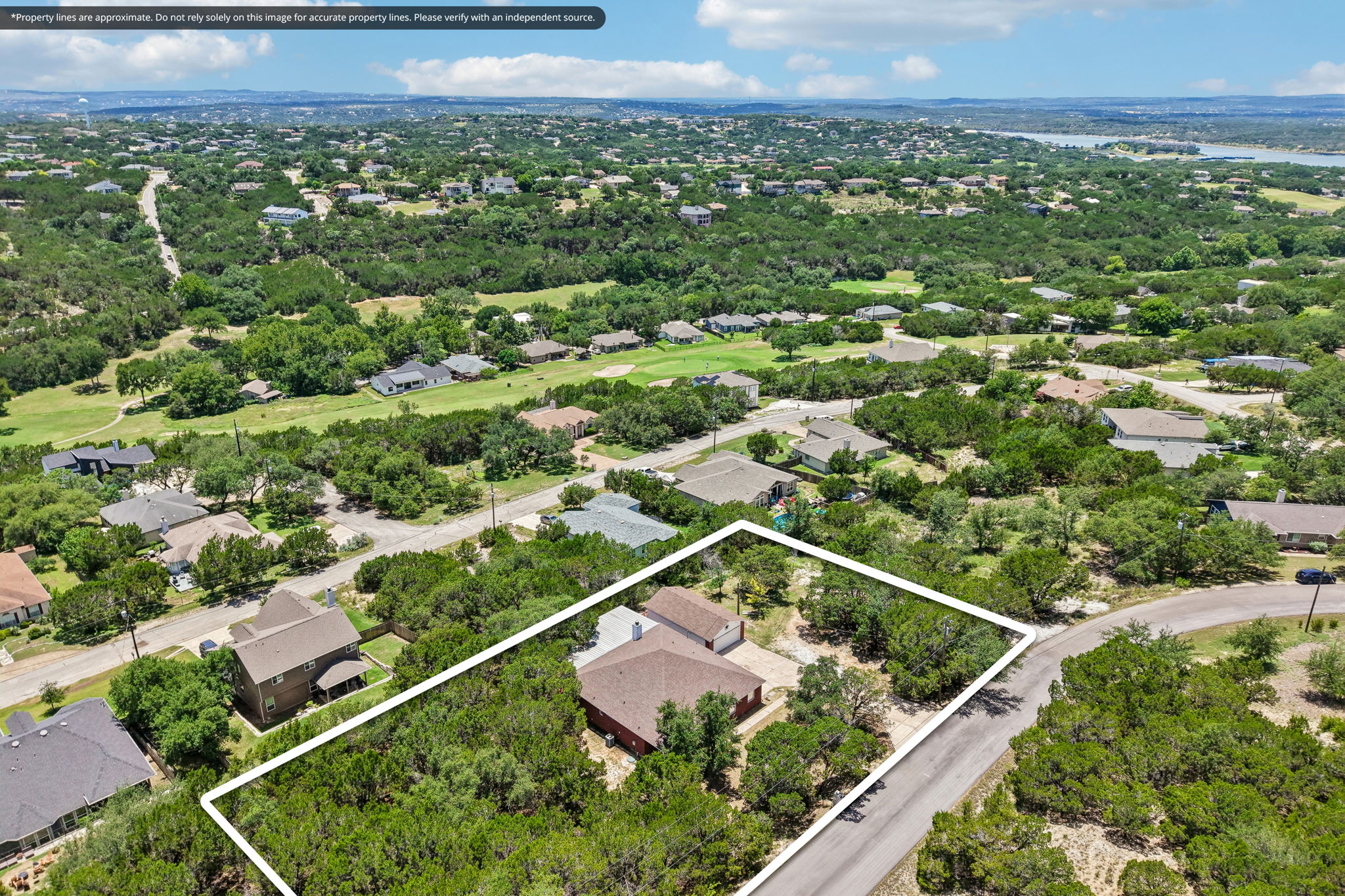 20609 Bridle Path Road Lago Vista, TX 78645 - Photo 23 of 30 An aerial perspective reveals a charming residential community nestled amongst abundant greenery and rolling hills.
