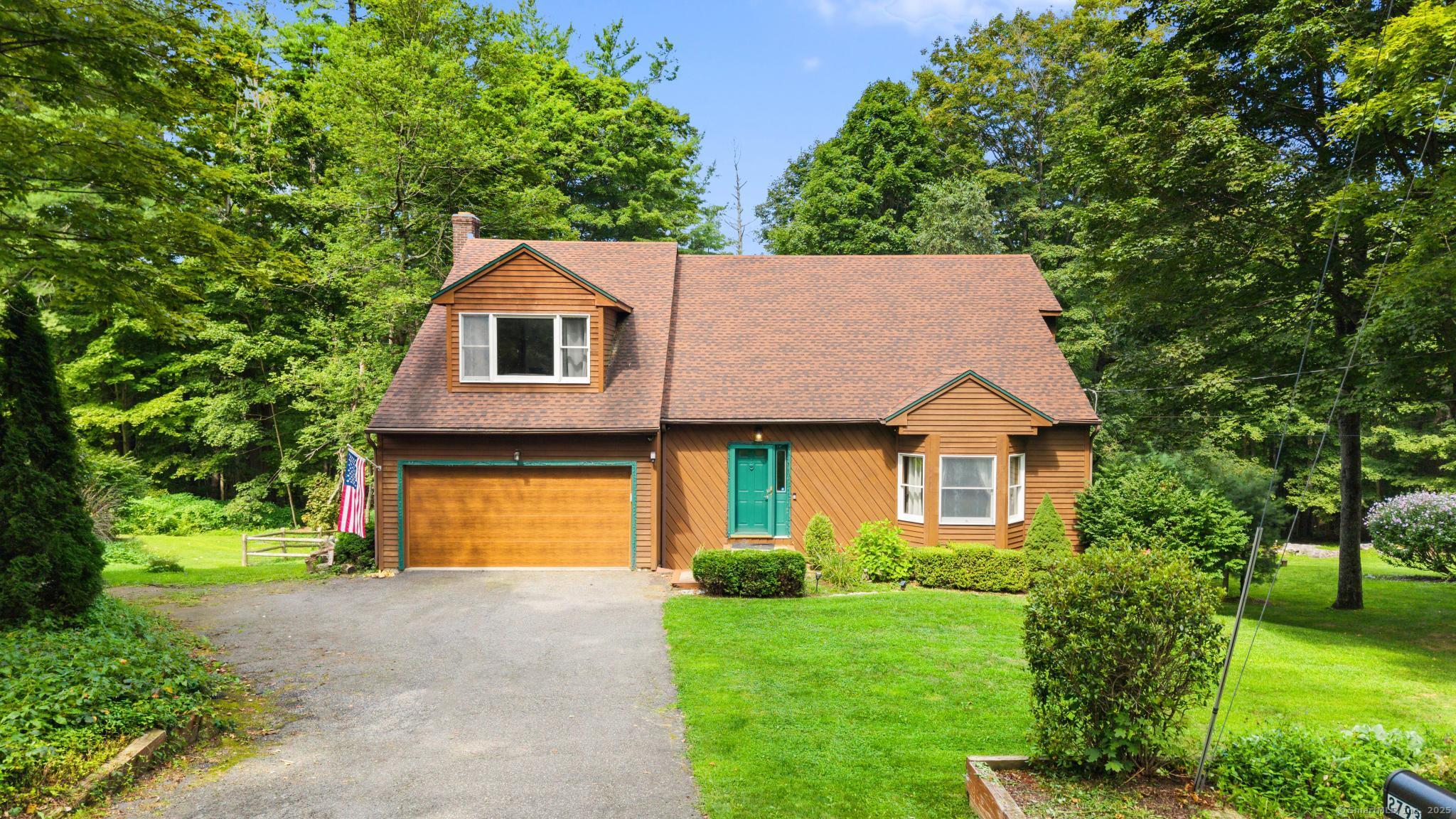 2793 Torringford W Street Torrington, CT 06790 - Photo 1 of 1 a front view of a house with a yard and garage