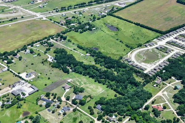an aerial view of residential house with outdoor space and swimming pool