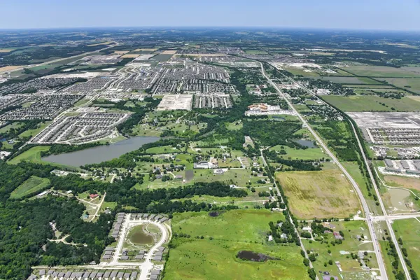 an aerial view of residential houses with outdoor space