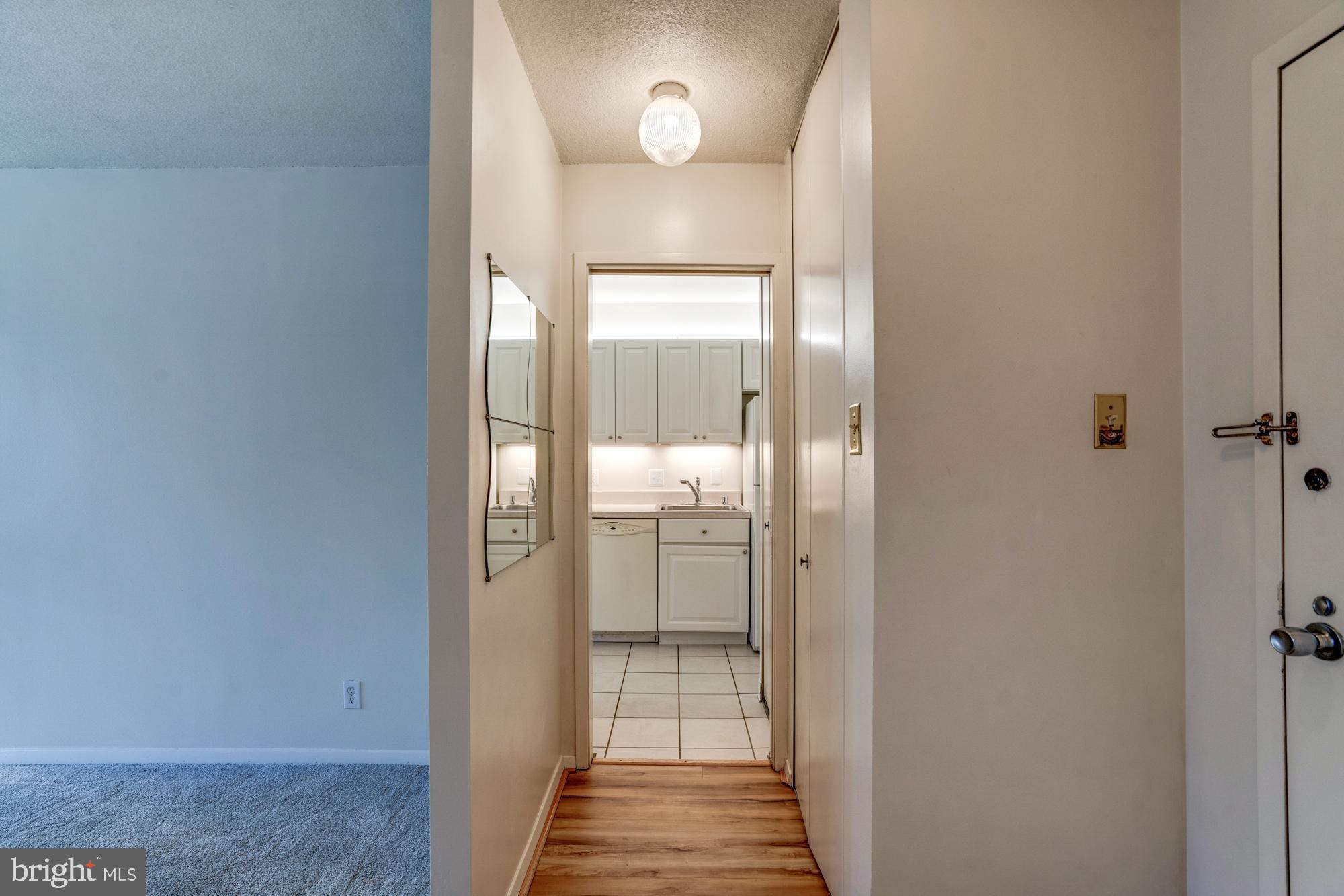 4515 Willard Avenue, Unit 719S Chevy Chase, MD 20815 - Photo 11 of 44 a view of a hallway with wooden floor and a bathroom