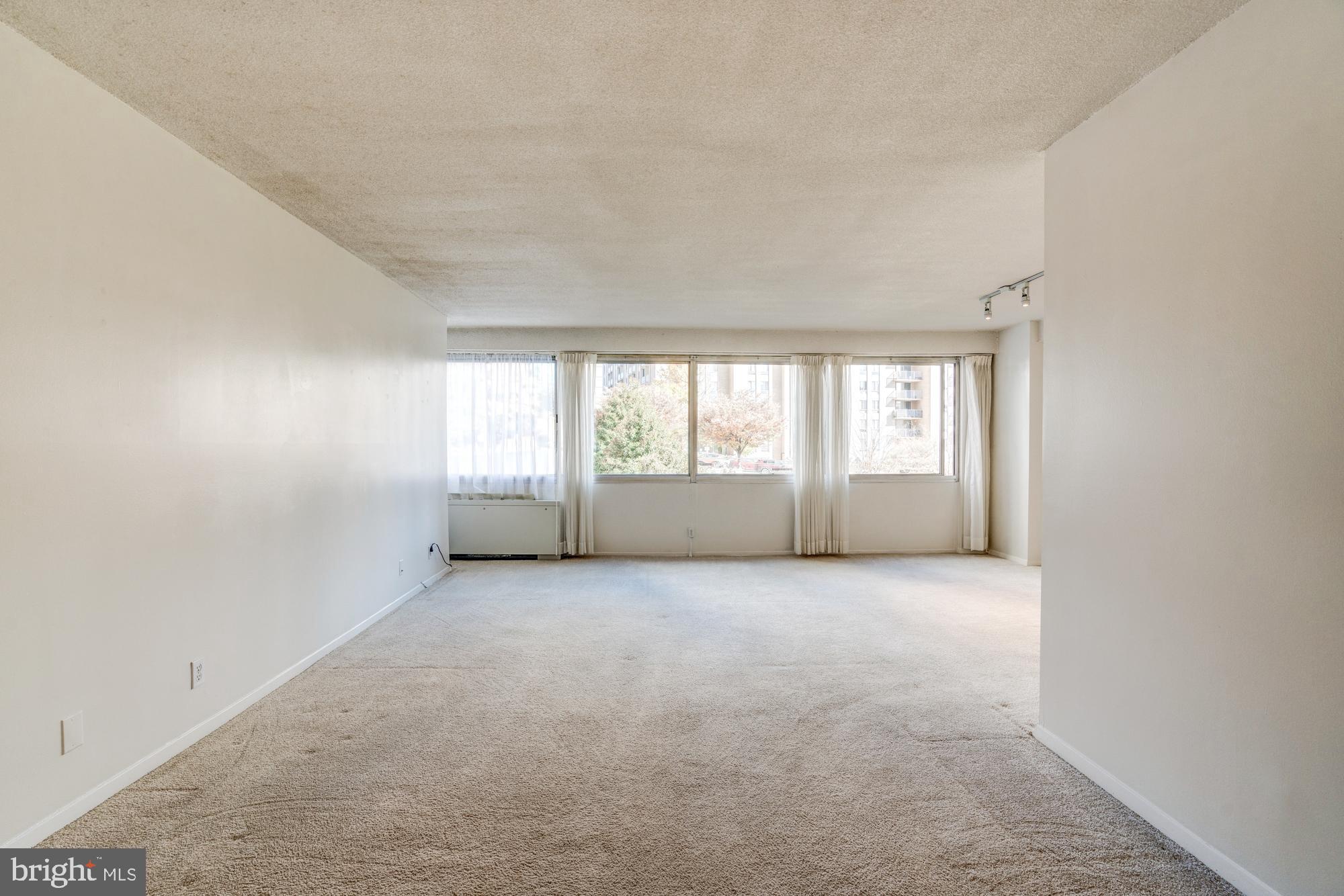 4515 Willard Avenue, Unit 719S Chevy Chase, MD 20815 - Photo 12 of 44 an empty room with windows