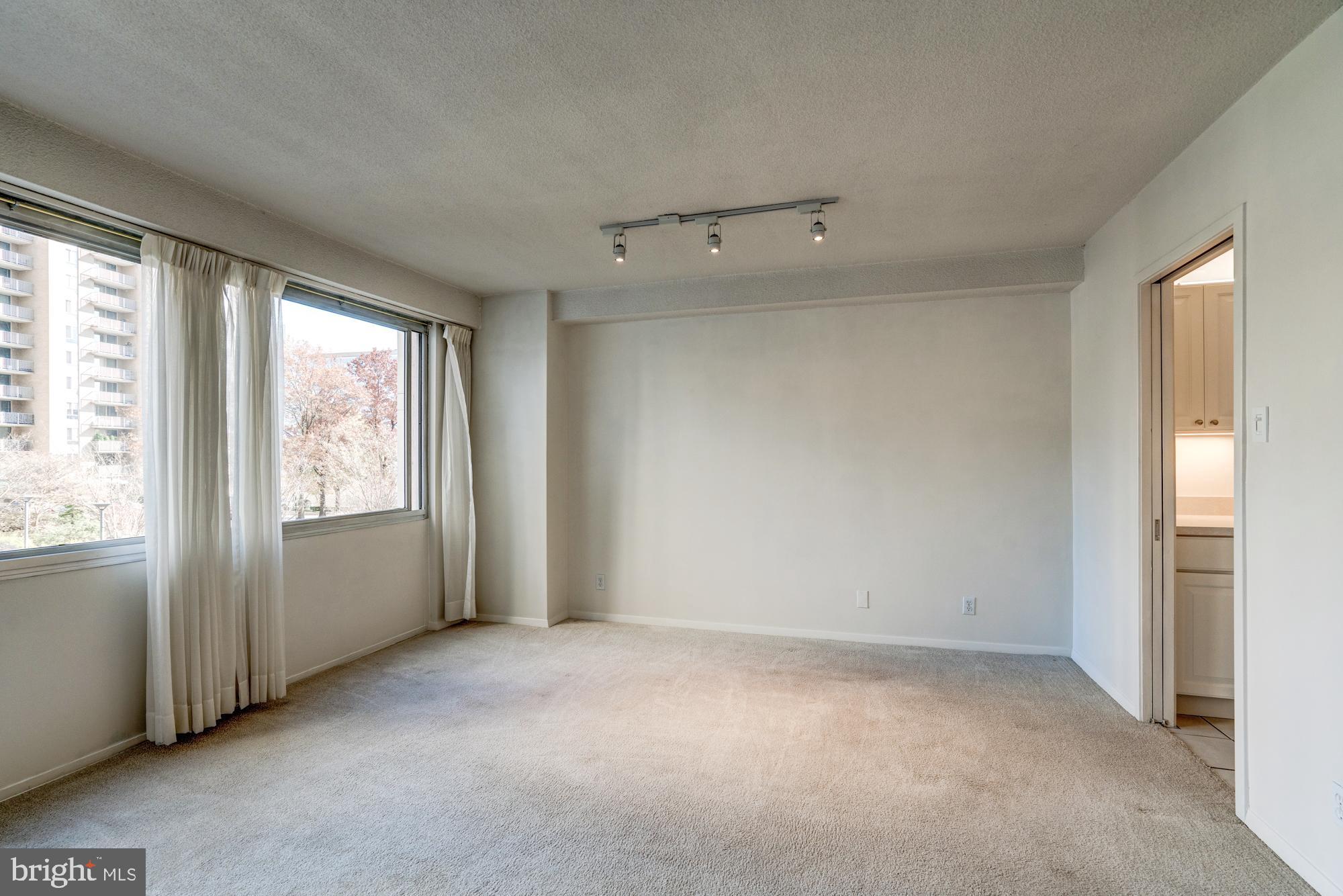 4515 Willard Avenue, Unit 719S Chevy Chase, MD 20815 - Photo 19 of 44 an empty room with windows