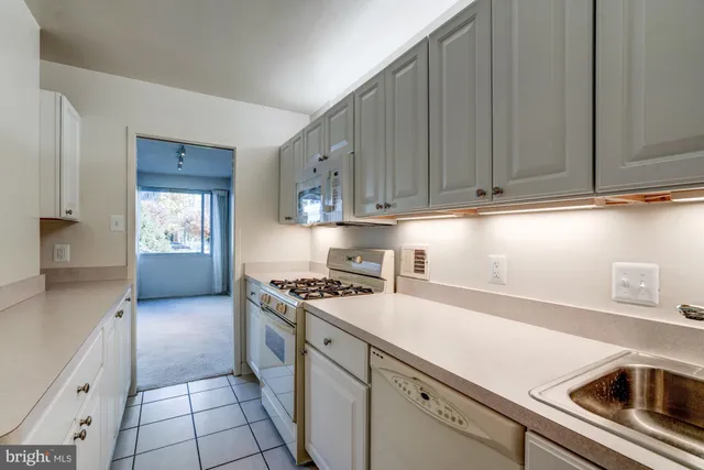 a white refrigerator freezer sitting inside of a kitchen