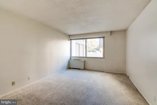 an empty room with large windows