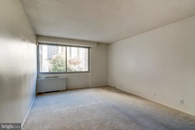 a view of an empty room and a window