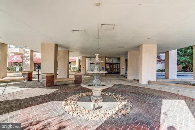 a living room with furniture a dining table and a large window with garden view