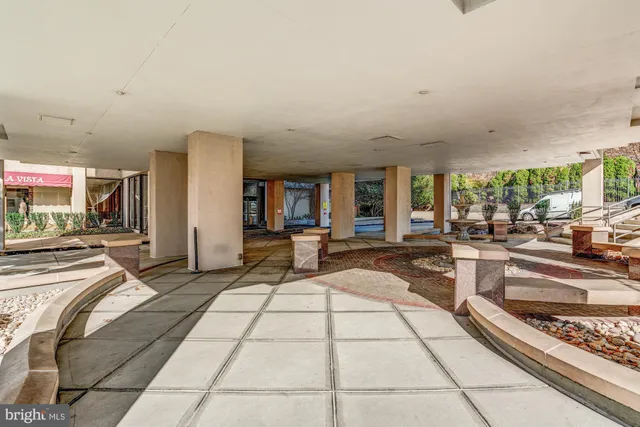 a lobby with furniture and view of living room