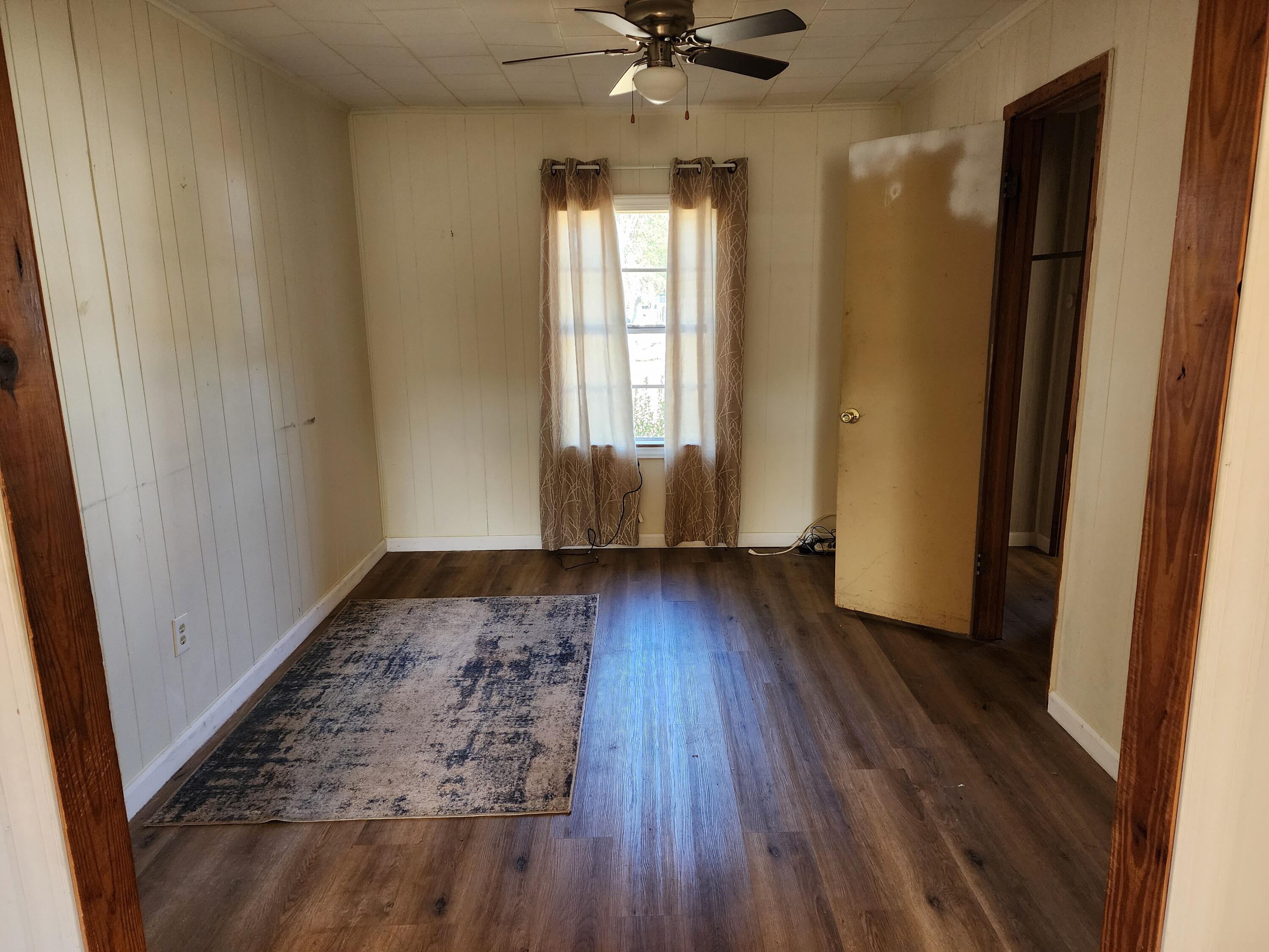 6181 Bethany Drive Crestview, FL 32539 - Photo 11 of 28 wooden floor in an empty room with a window