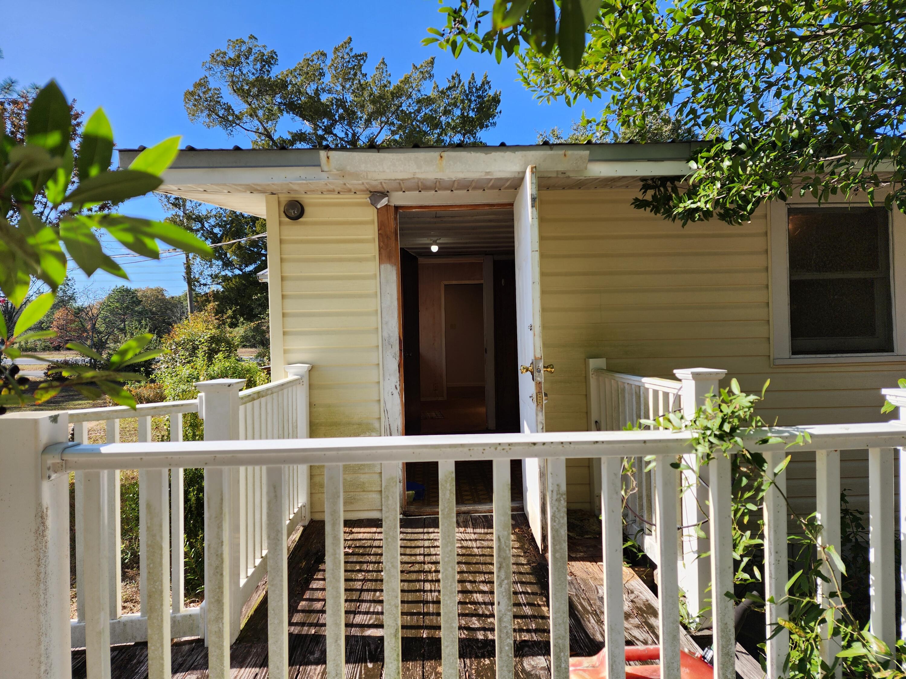 6181 Bethany Drive Crestview, FL 32539 - Photo 19 of 28 a view of a pathway of a house with a flower garden
