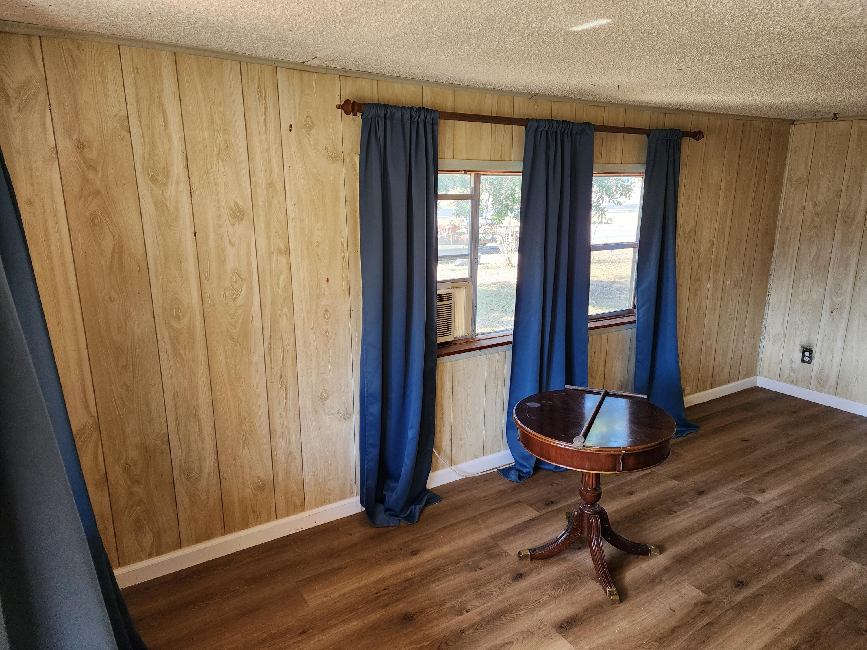 6181 Bethany Drive Crestview, FL 32539 - Photo 2 of 28 a room with wooden floor and a window
