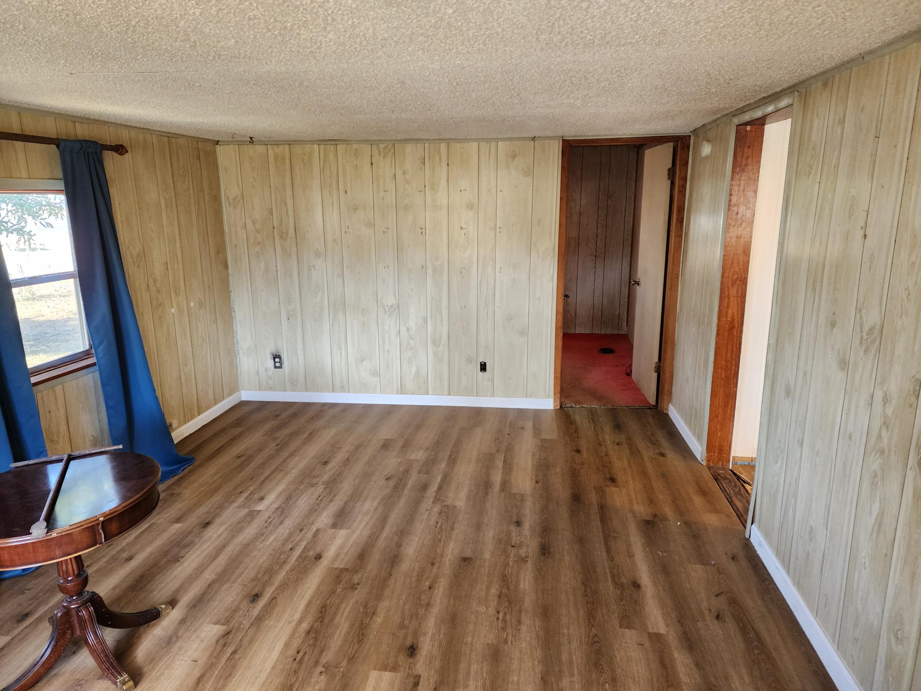 6181 Bethany Drive Crestview, FL 32539 - Photo 3 of 28 a view of empty room with wooden floor and fan