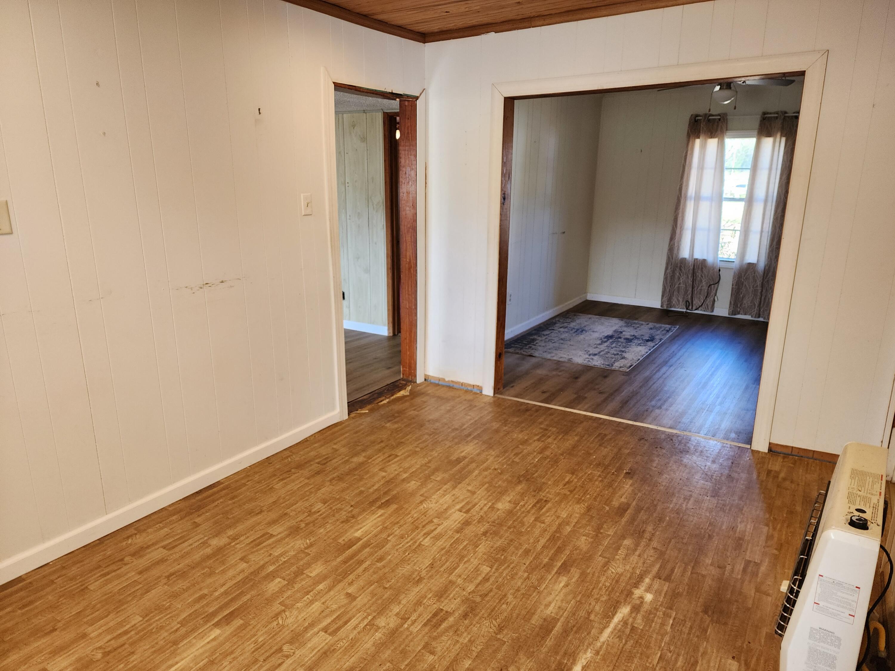 6181 Bethany Drive Crestview, FL 32539 - Photo 10 of 28 an empty room with wooden floor and windows