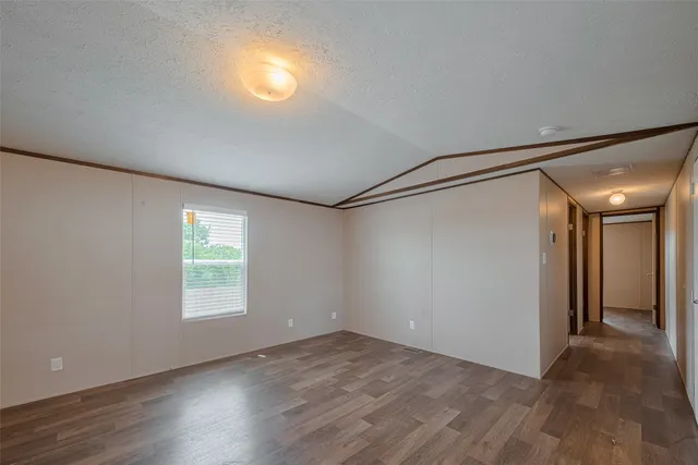 an empty room with a empty space and windows