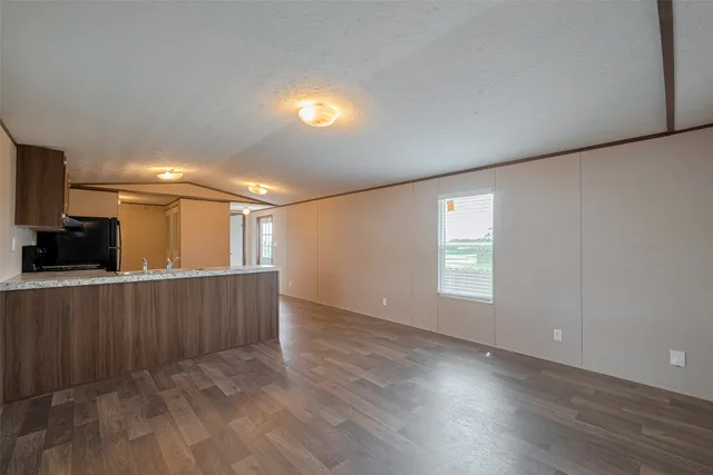 a view of hallway with wooden floor