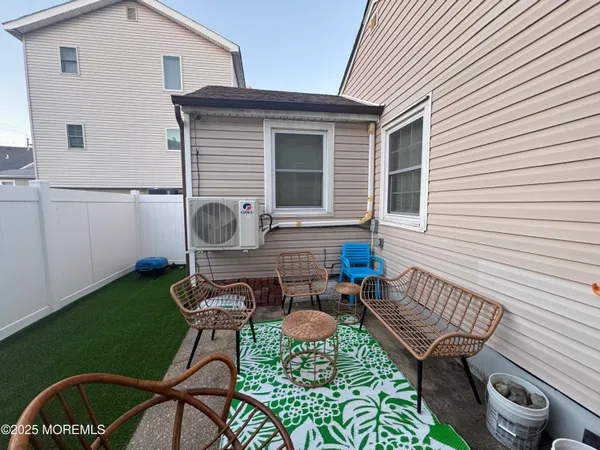 a balcony with table and chairs