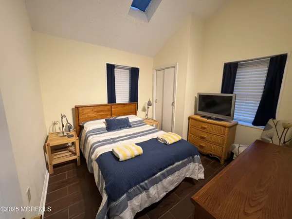a bedroom with a bed and flat screen tv