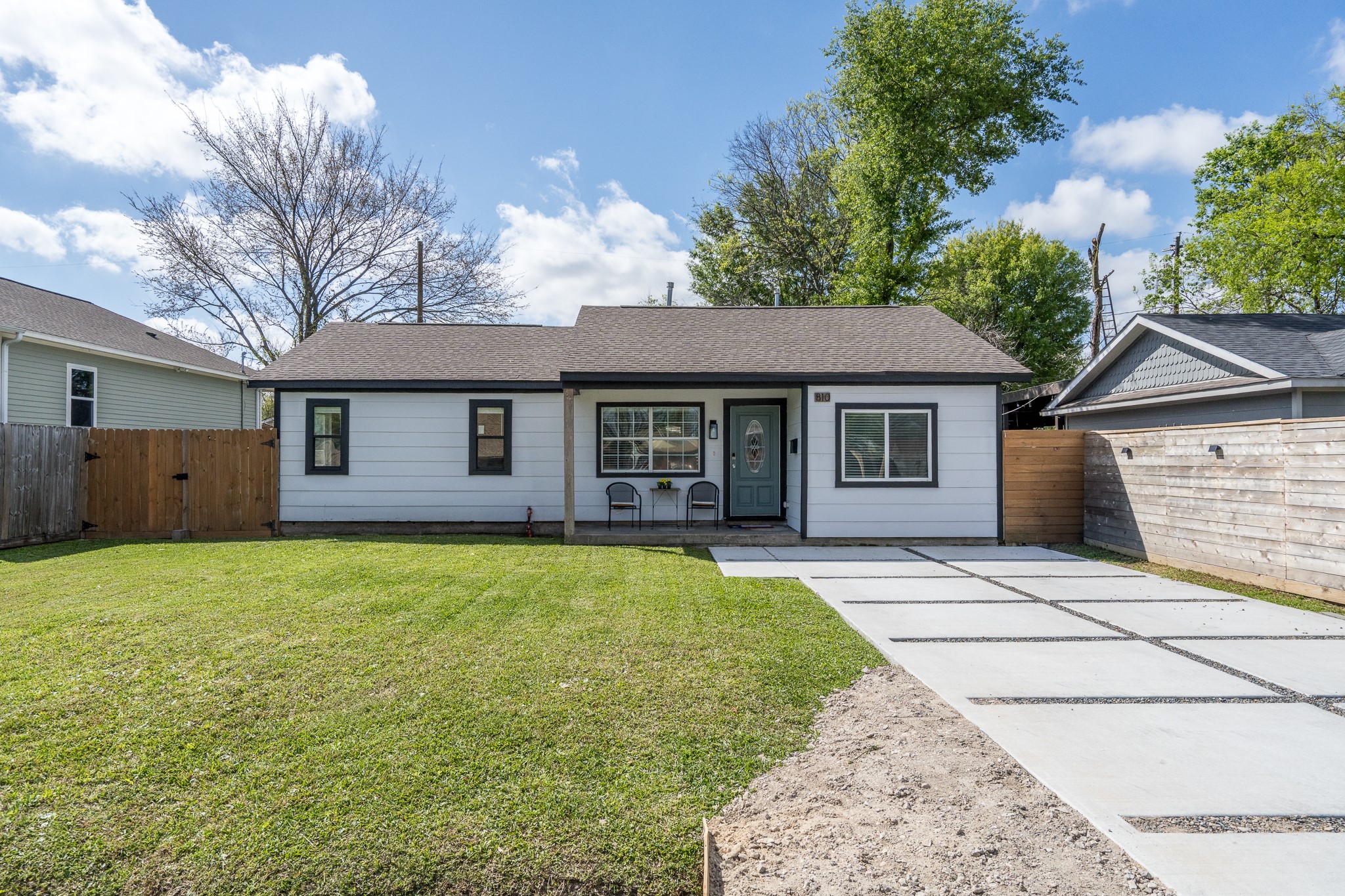 a front view of a house with a garden and yard