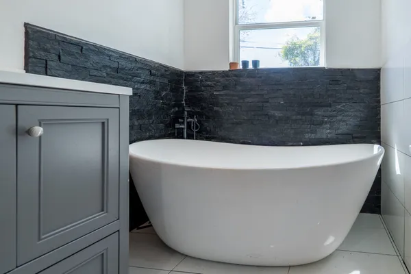 a white bath tub sitting in a bathroom