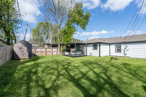 a view of a house with backyard and sitting area