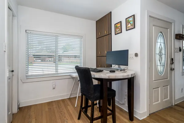 a view of a dining room with furniture and window