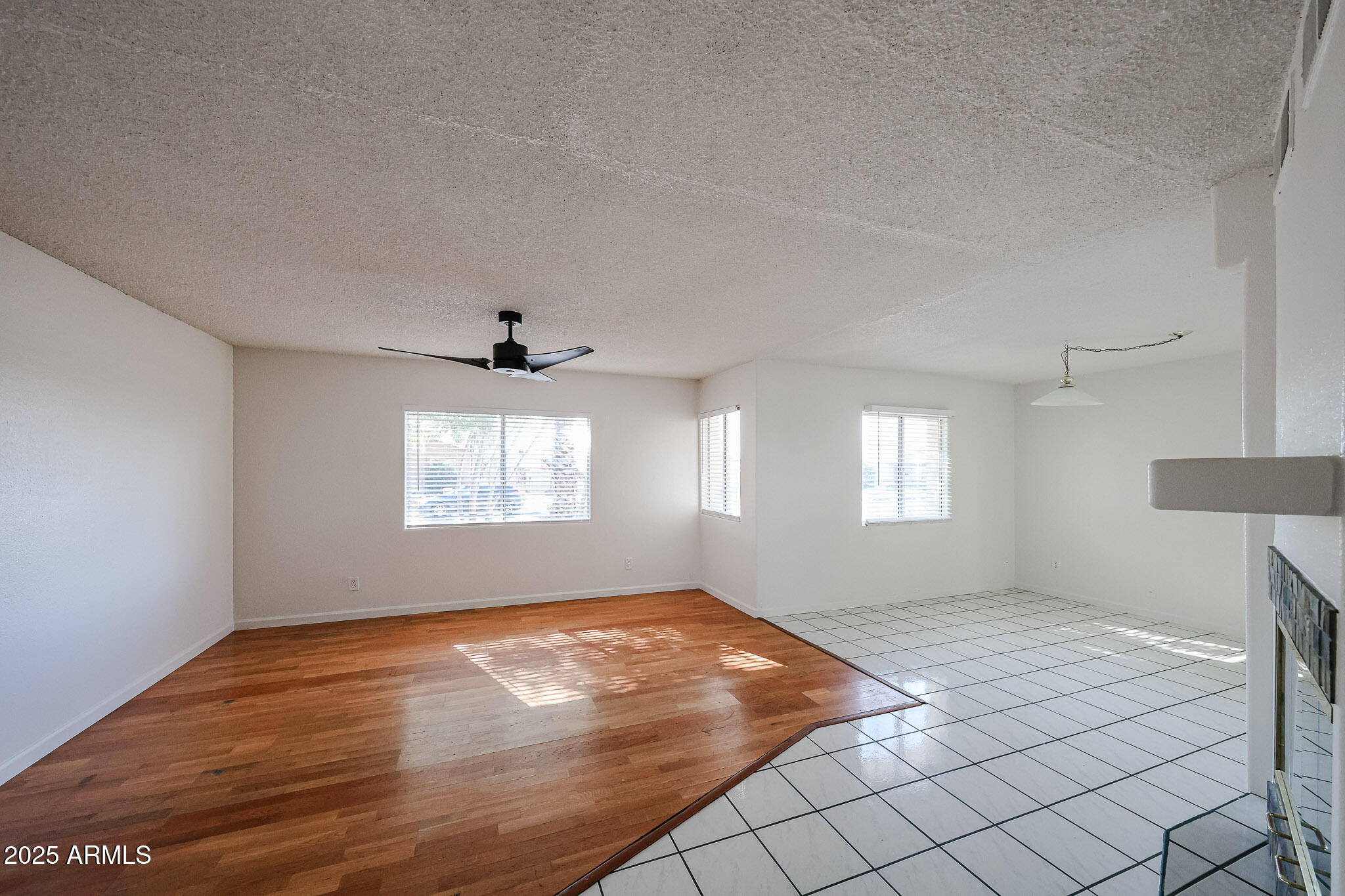 3408 West Port Au Prince Lane Phoenix, AZ 85053 - Photo 15 of 61 an empty room with windows and fan
