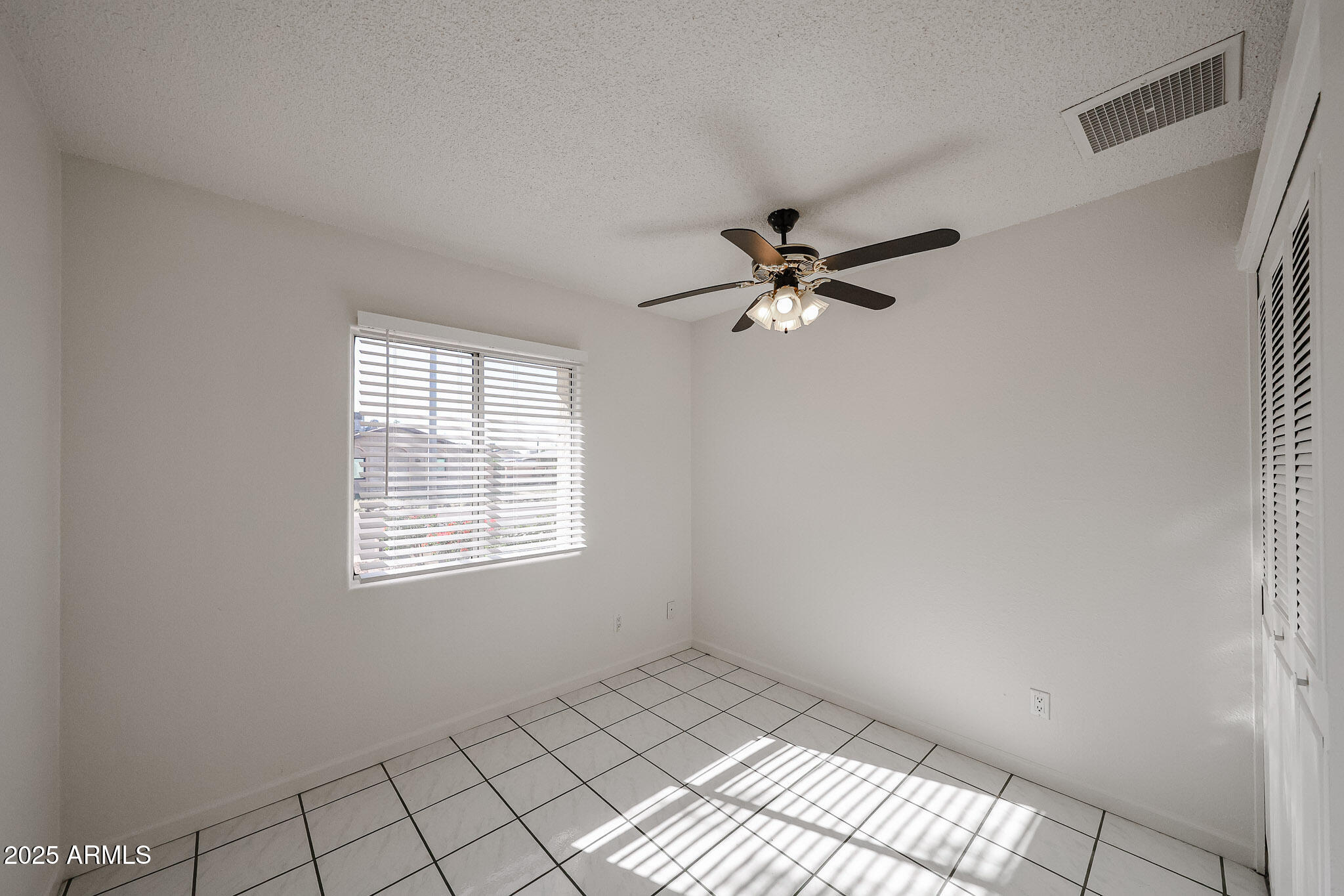 3408 West Port Au Prince Lane Phoenix, AZ 85053 - Photo 16 of 61 a view of an empty room with a window