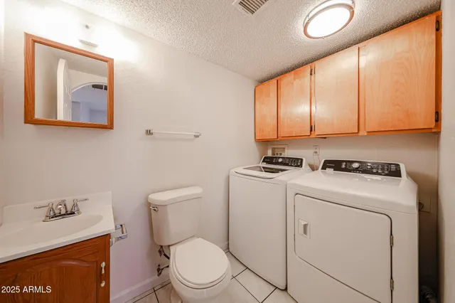 a large kitchen with stainless steel appliances granite countertop a stove a sink and a refrigerator