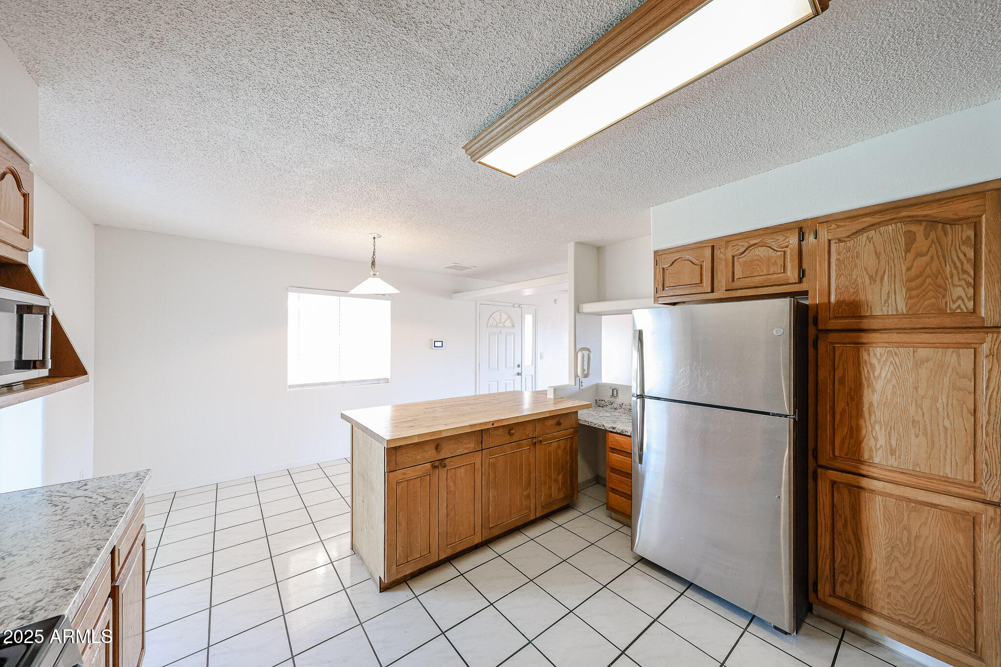 3408 West Port Au Prince Lane Phoenix, AZ 85053 - Photo 26 of 61 a kitchen with a refrigerator a stove top oven and cabinets