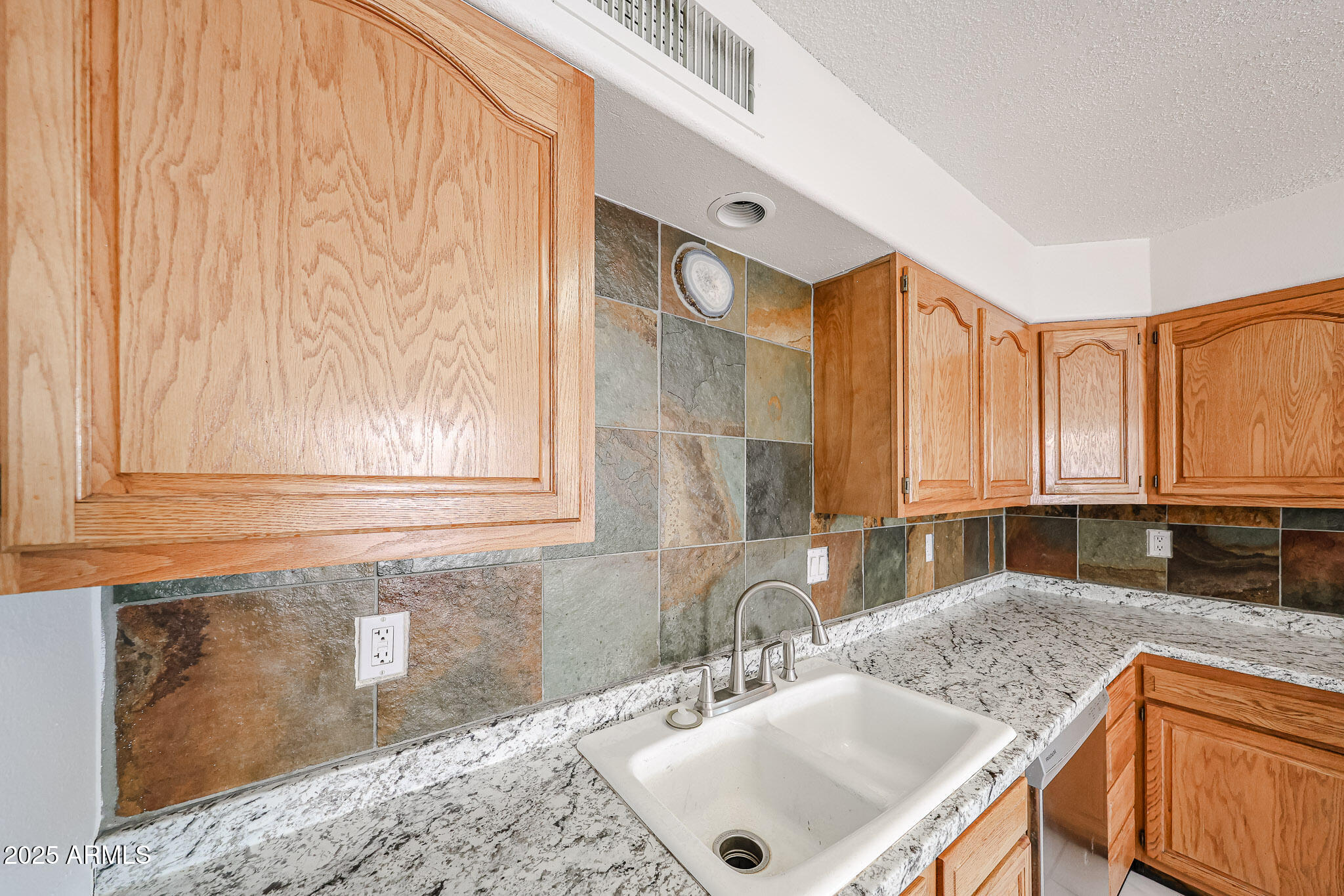 3408 West Port Au Prince Lane Phoenix, AZ 85053 - Photo 28 of 61 a kitchen with granite countertop a sink and a window
