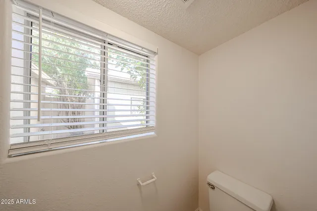 a view of a livingroom with furniture and kitchen view