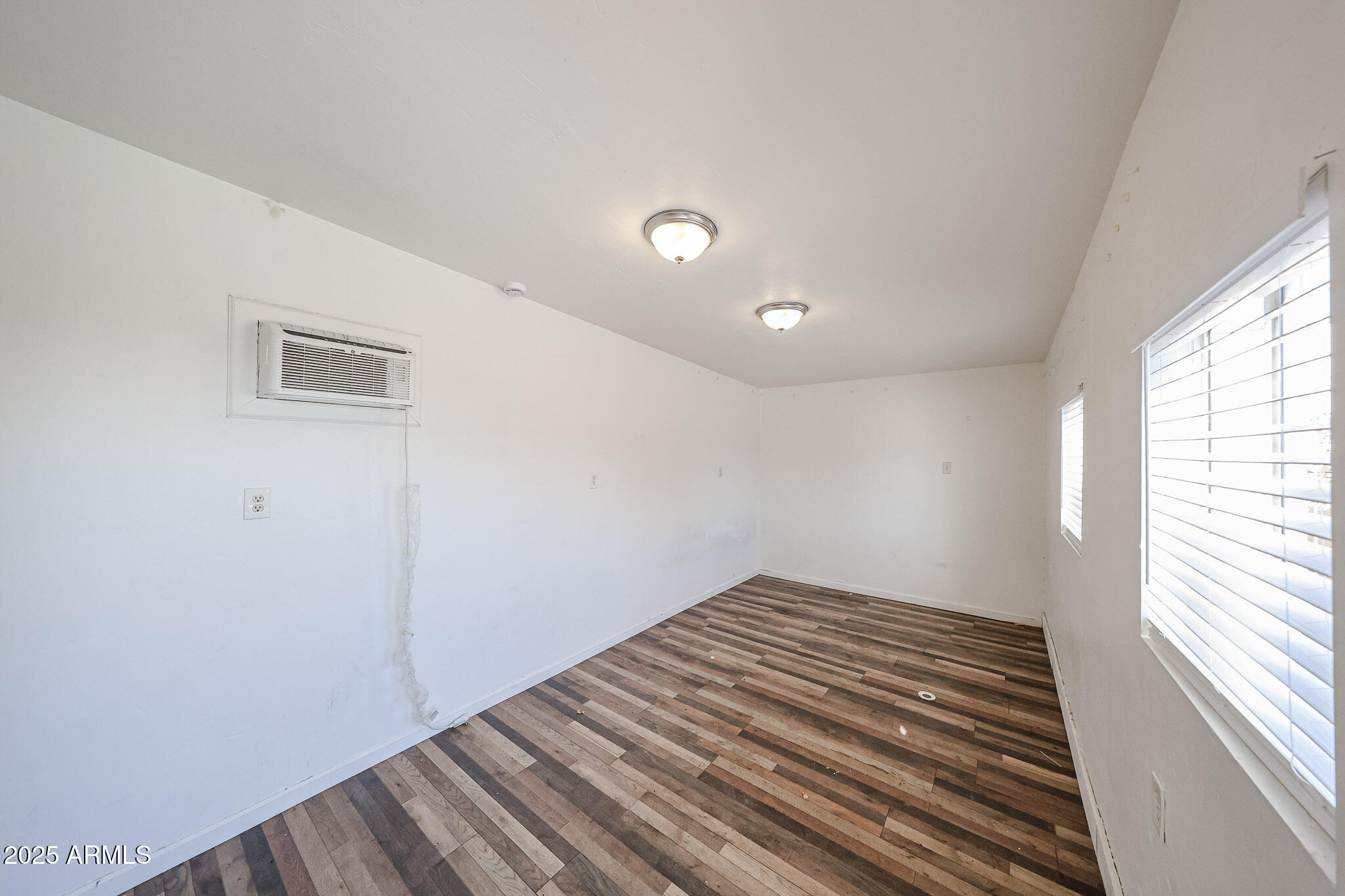 3408 West Port Au Prince Lane Phoenix, AZ 85053 - Photo 40 of 61 a view of a room with wooden floor and staircase