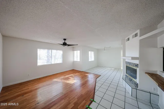 a view of a living room hardwood floor and a kitchen