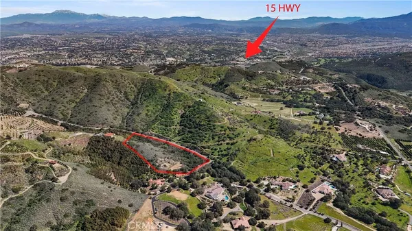 a view of a lush green hillside and a houses