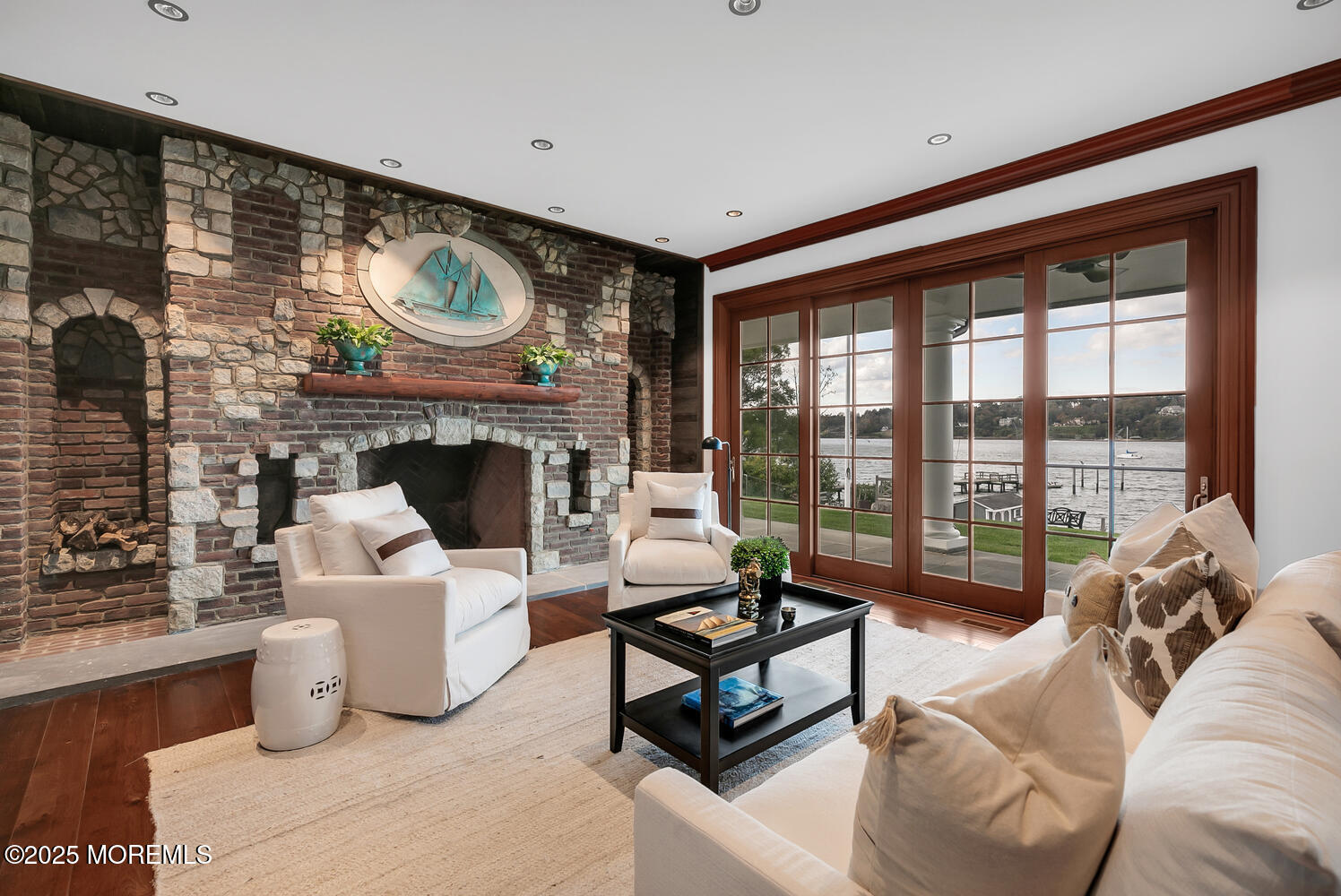 1 2nd Street Rumson, NJ 07760 - Photo 7 of 39 a living room with furniture a fireplace and a floor to ceiling window