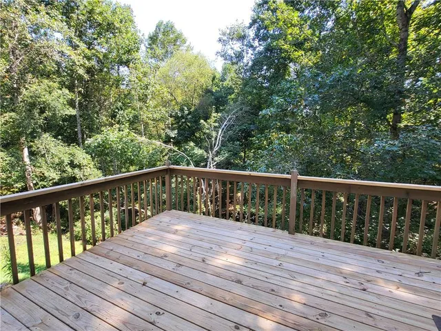 a balcony with wooden floor and fence