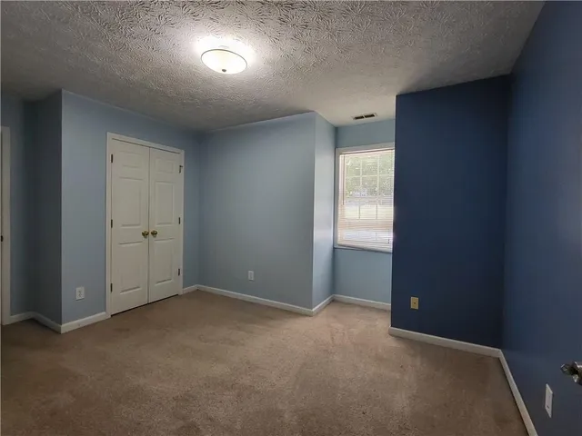 a view of an empty room and a window