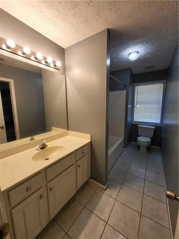 a bathroom with a sink a vanity and a mirror