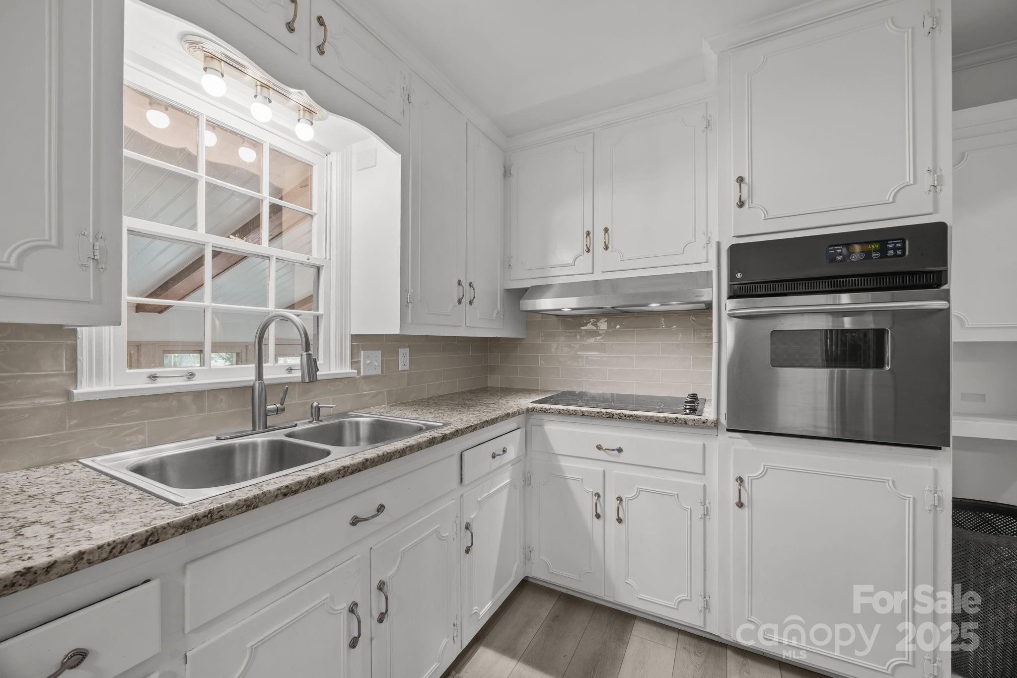 241 Stonewall Road Salisbury, NC 28144 - Photo 15 of 48 a kitchen with granite countertop white cabinets and stainless steel appliances
