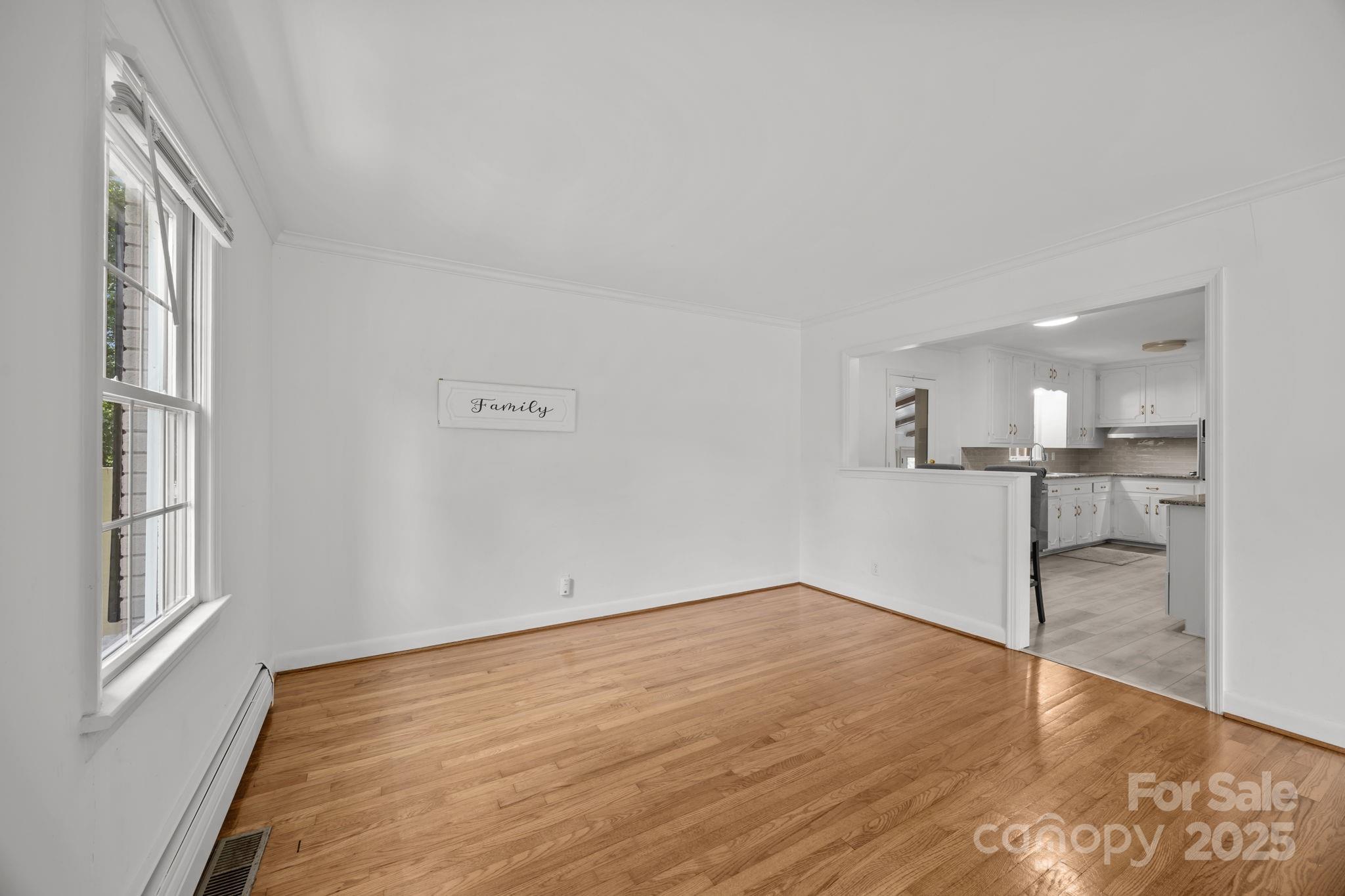 241 Stonewall Road Salisbury, NC 28144 - Photo 22 of 48 a view of empty room with wooden floor and windows